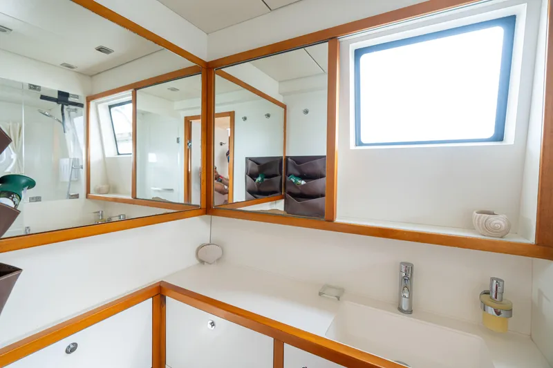 LibertÉ Yacht Photos Pics Luxurious bathroom interior of 2011 Lagoon 560 yacht with mirrors and modern fixtures.