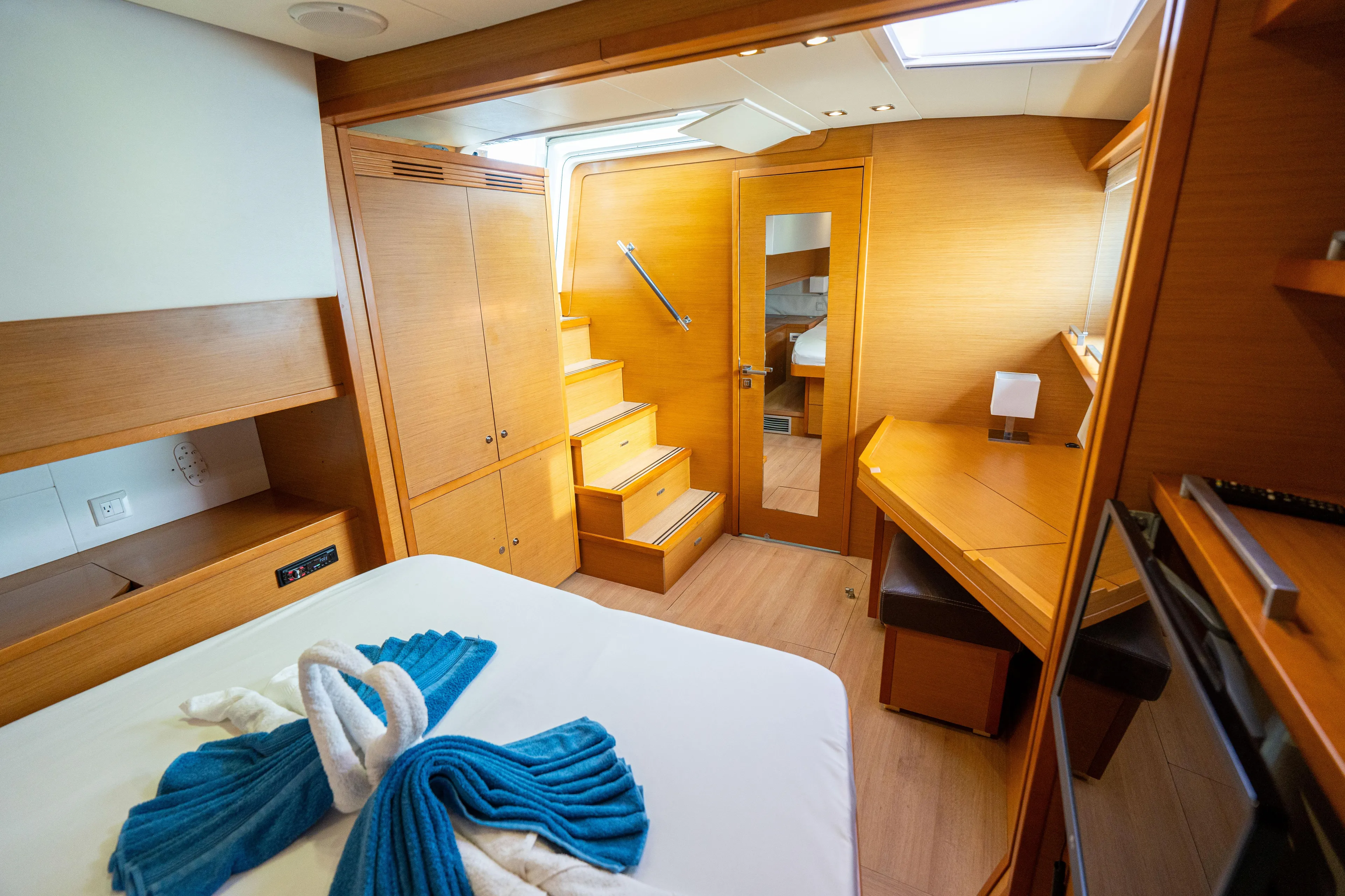 LibertÉ Yacht Photos Pics Luxurious interior of 2011 Lagoon 560 yacht cabin with wooden furnishings and elegant decor.