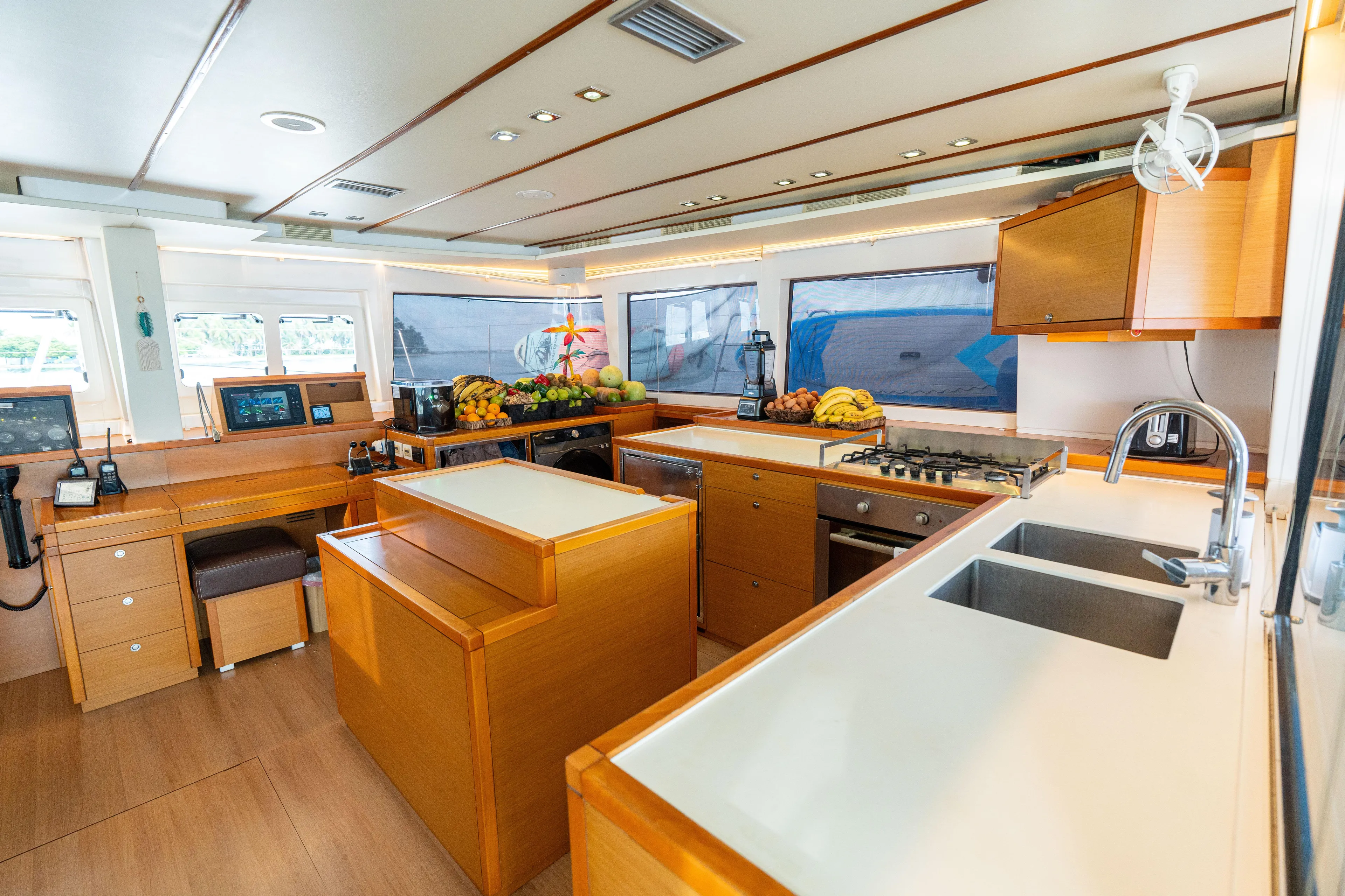 LibertÉ Yacht Photos Pics Luxurious kitchen interior of 2011 Lagoon 560 yacht with modern amenities and wooden finishes.