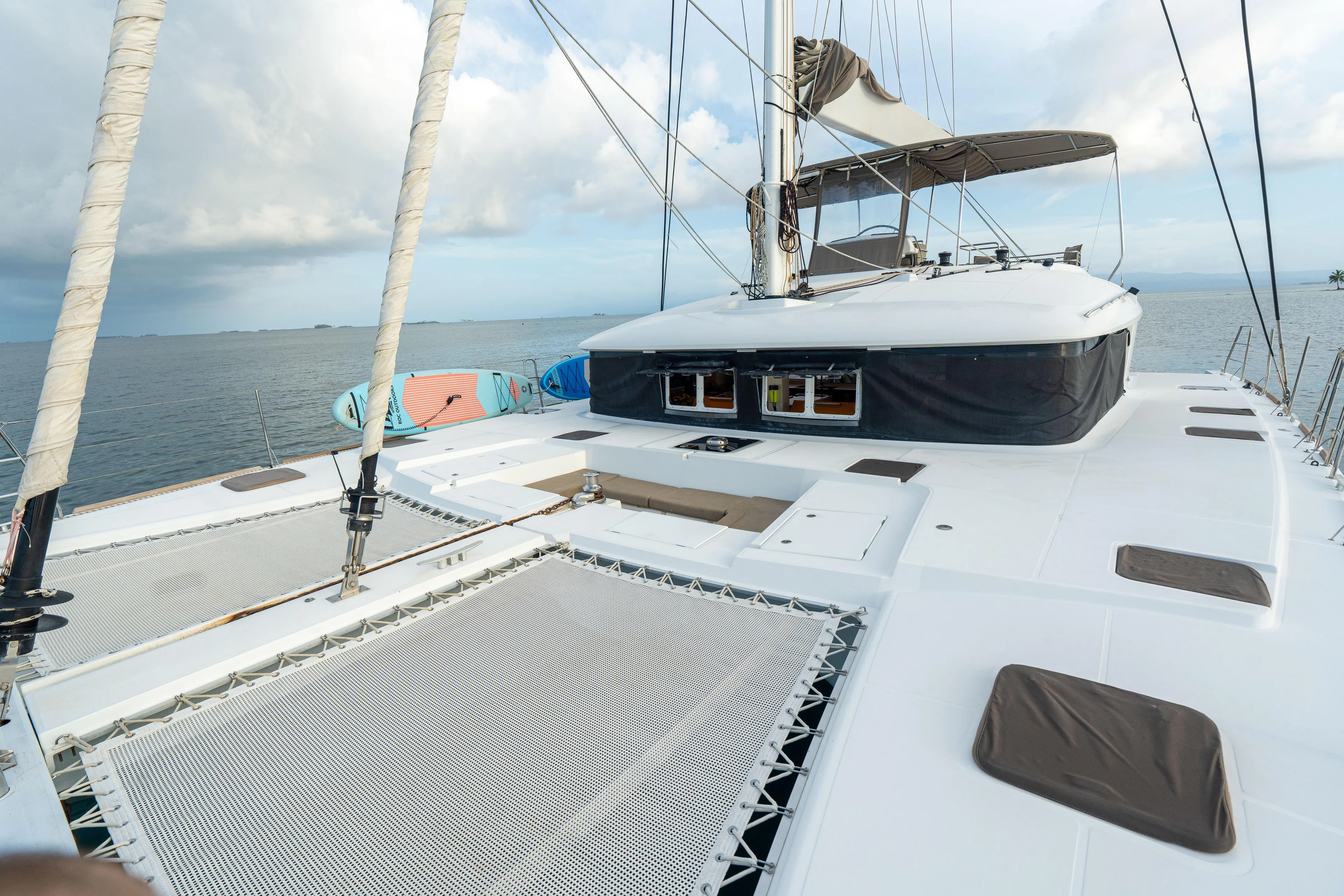LibertÉ Yacht Photos Pics Lagoon 560 catamaran deck, 2011 model, with spacious netting and ocean view.
