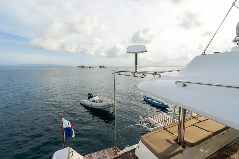 LibertÉ Yacht Photos Pics Lagoon 560 yacht on calm sea with small boats nearby, 2011 model.