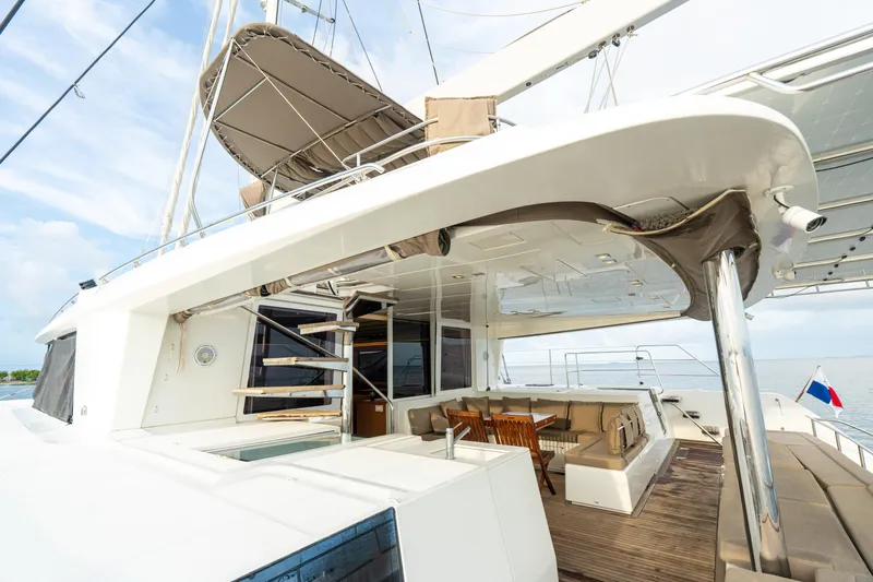LibertÉ Yacht Photos Pics Lagoon 560 catamaran, 2011 model, featuring spacious deck and seating area under a canopy.