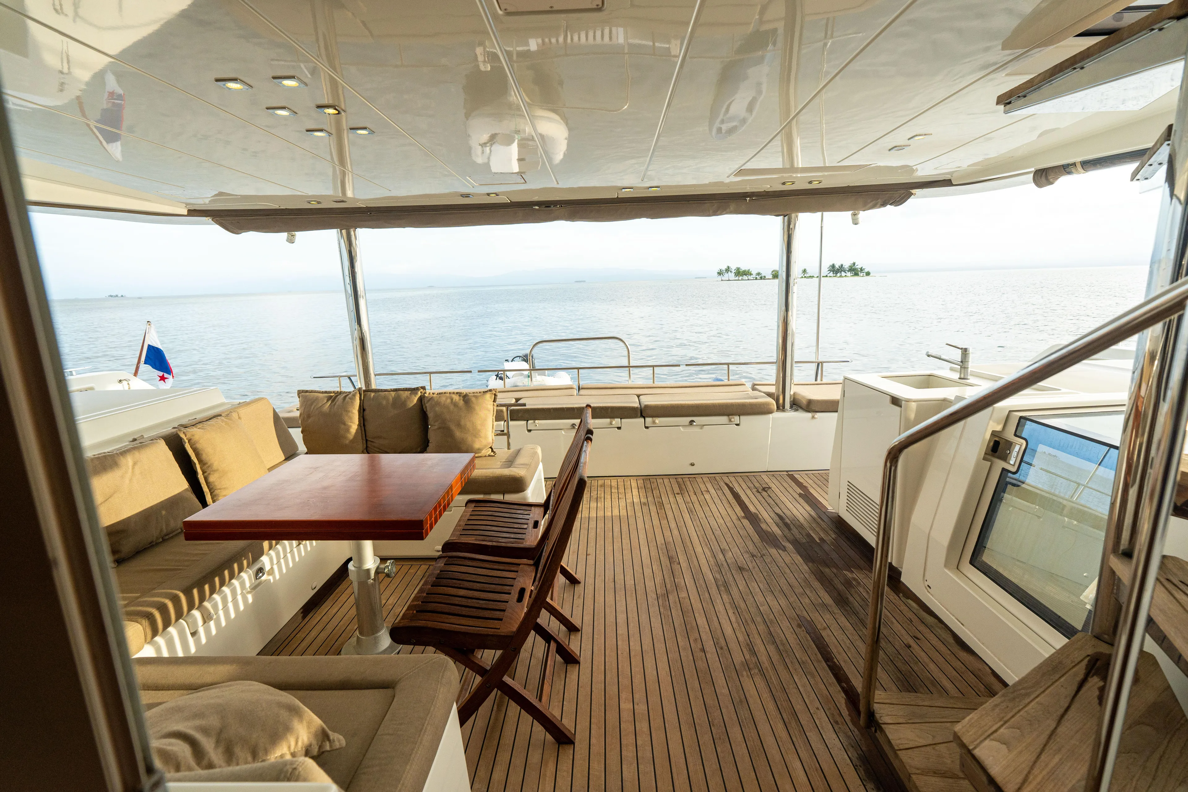 LibertÉ Yacht Photos Pics Luxurious Lagoon 560 yacht deck with seating, table, and ocean view, 2011 model.