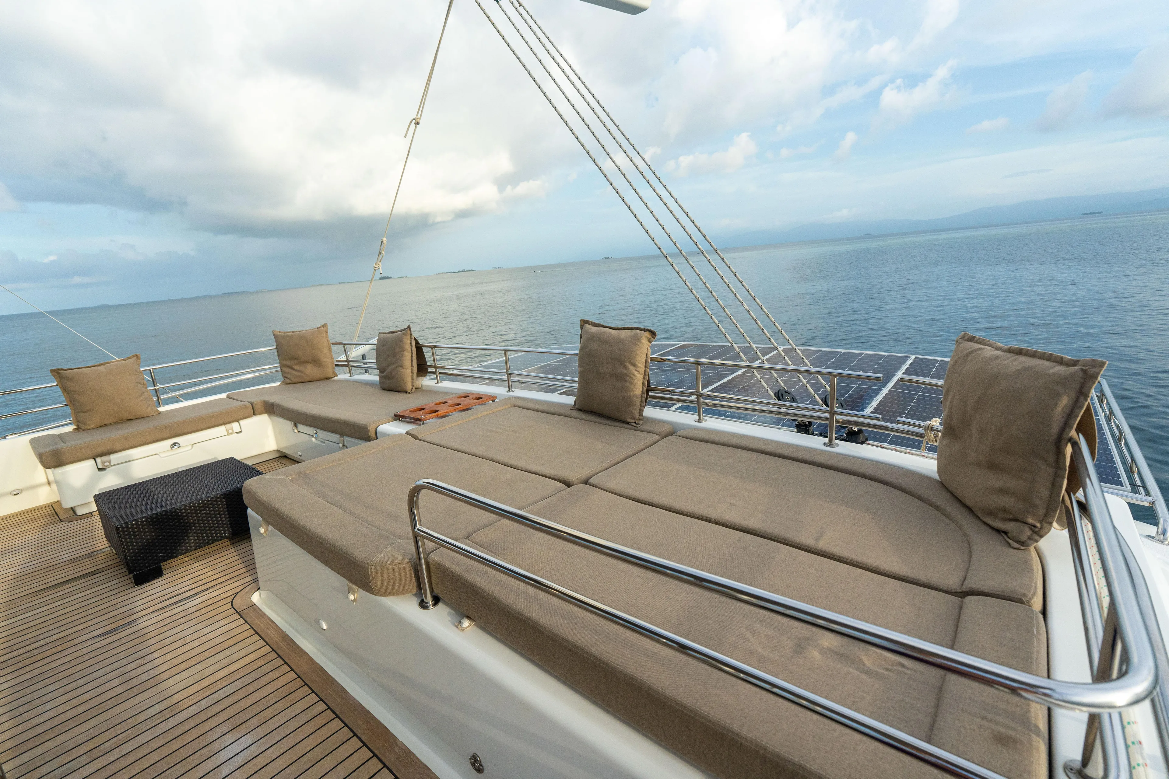 LibertÉ Yacht Photos Pics Luxurious deck of 2011 Lagoon 560 yacht with cushioned seating and ocean view.