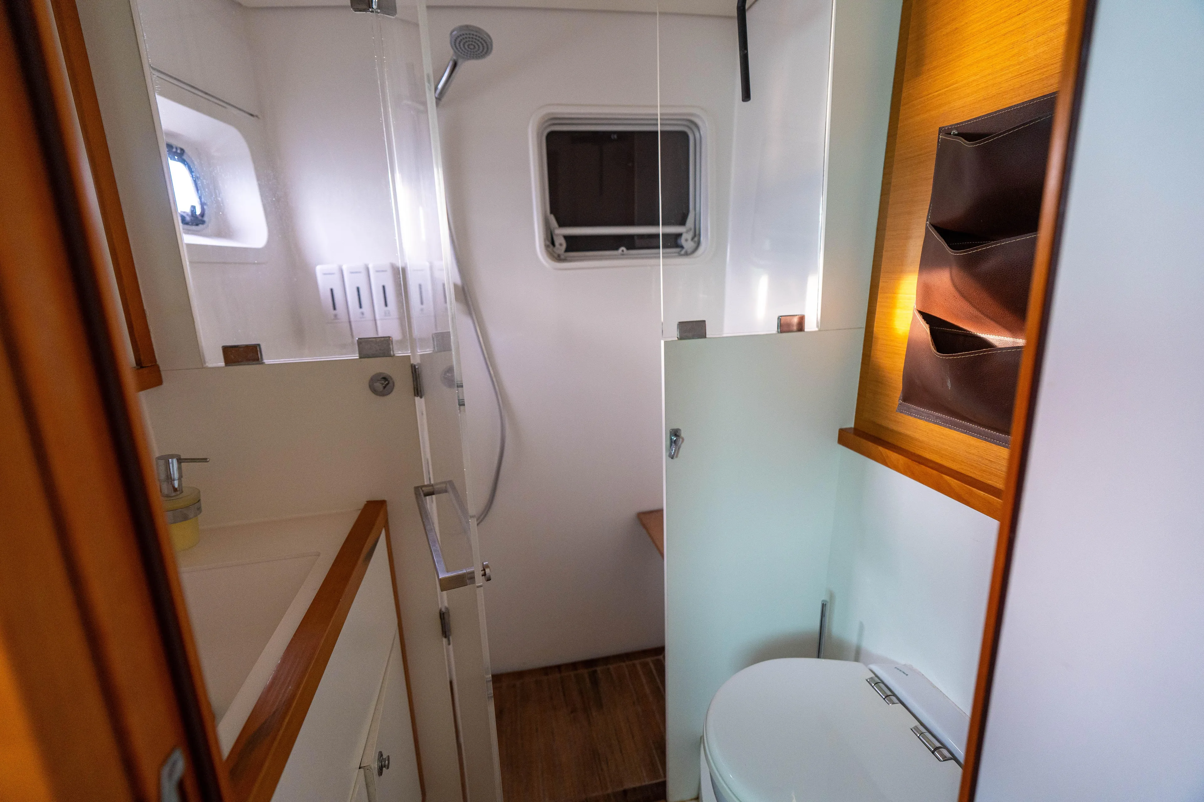 LibertÉ Yacht Photos Pics Bathroom interior of a 2011 Lagoon 560 yacht, featuring a shower and toilet.