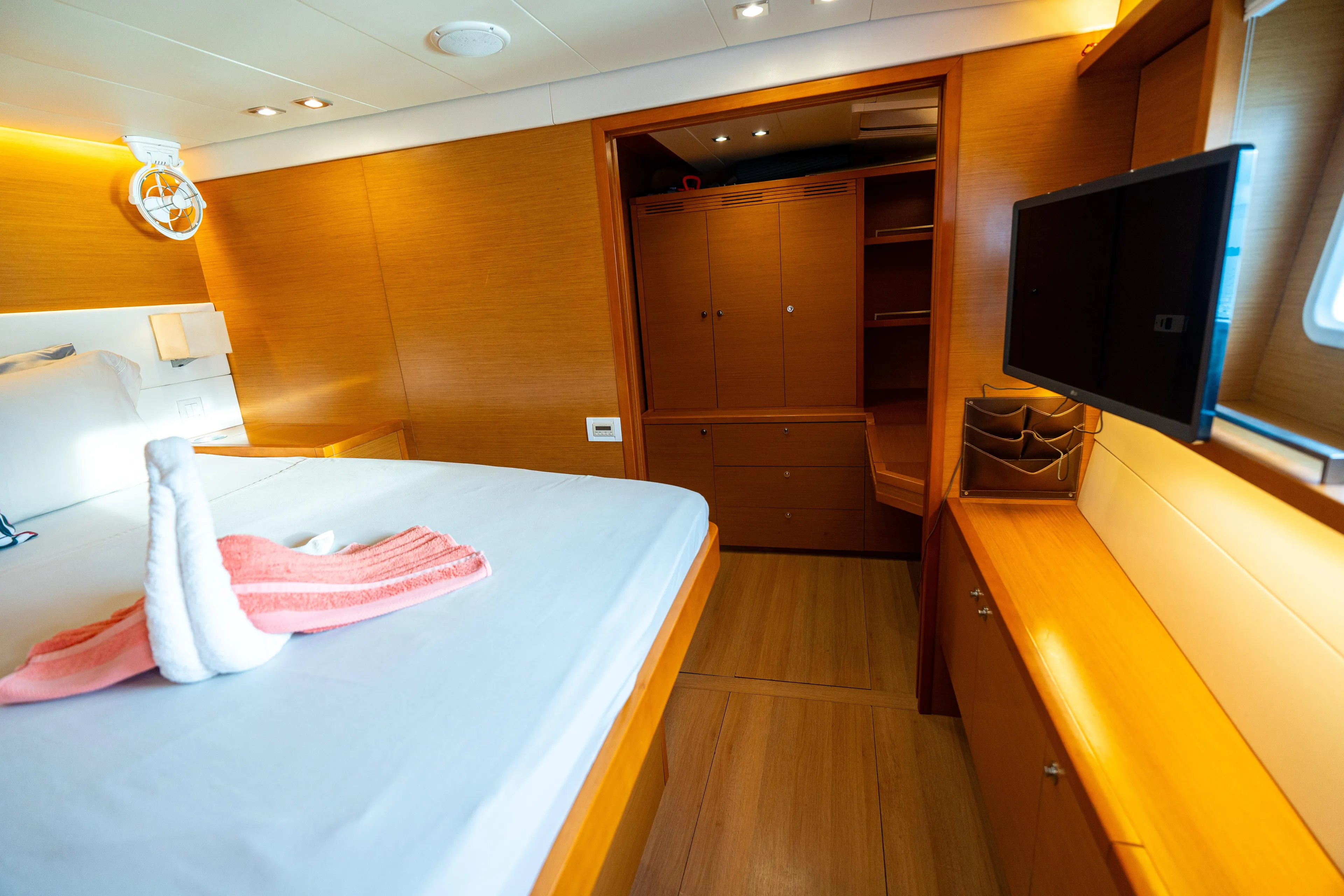 LibertÉ Yacht Photos Pics Luxurious cabin interior of 2011 Lagoon 560 yacht with wood finish and modern amenities.