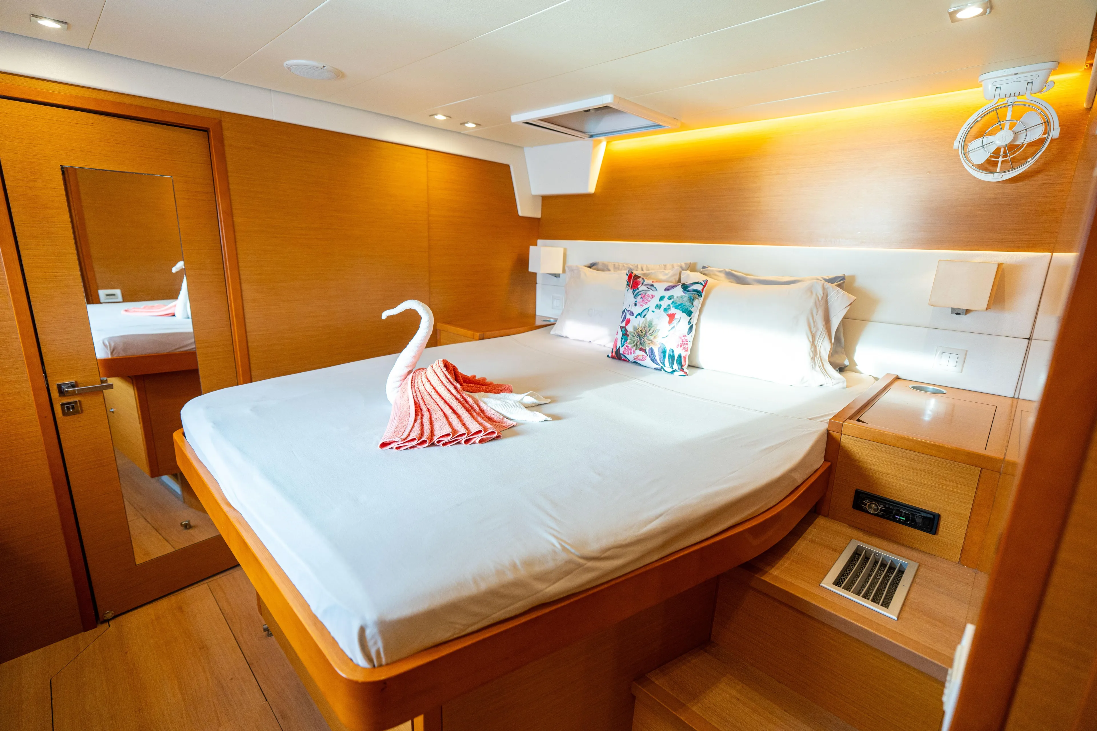 LibertÉ Yacht Photos Pics Luxurious cabin interior of 2011 Lagoon 560 yacht with elegant bedding and ambient lighting.