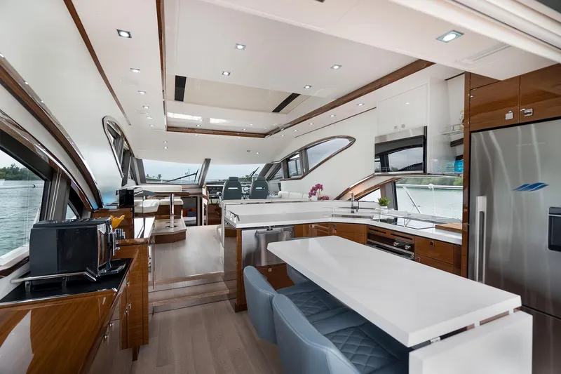  Yacht Photos Pics Luxurious interior of 2026 Neptunus 650E yacht with modern kitchen and seating area.