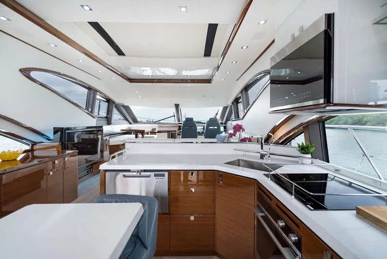  Yacht Photos Pics Luxurious interior of 2026 Neptunus 650E yacht with modern kitchen and panoramic windows.