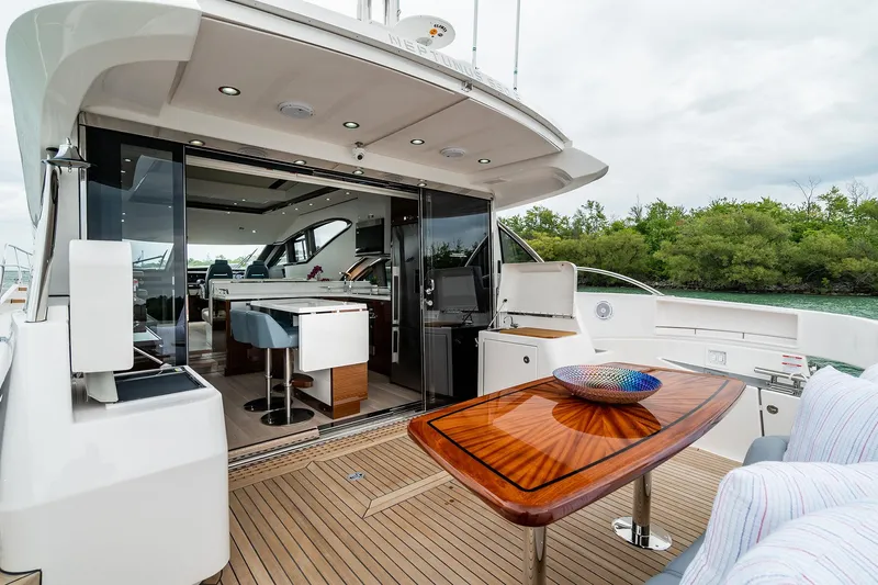  Yacht Photos Pics Luxurious Neptunus 650E yacht interior with elegant wooden table, modern design, and scenic view, 2026 model.