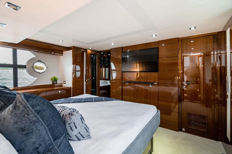  Yacht Photos Pics Luxurious bedroom interior of 2026 Neptunus 650E yacht with modern wood finishes.