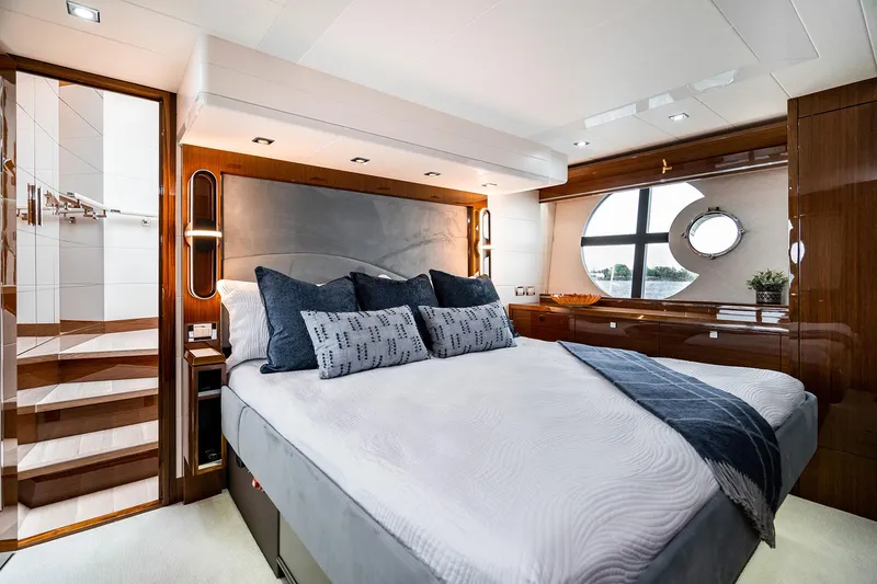  Yacht Photos Pics Luxurious bedroom interior of 2026 Neptunus 650E yacht with modern design and elegant furnishings.