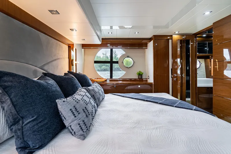  Yacht Photos Pics Luxurious Neptunus 650E 2026 yacht bedroom with elegant wood finishes and modern decor.