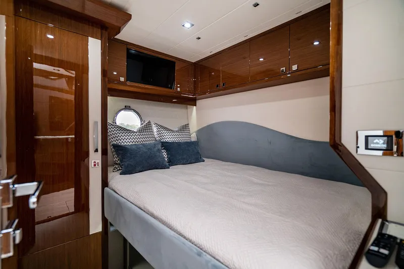  Yacht Photos Pics Luxurious cabin interior of 2026 Neptunus 650E yacht with modern bedding and wood finishes.