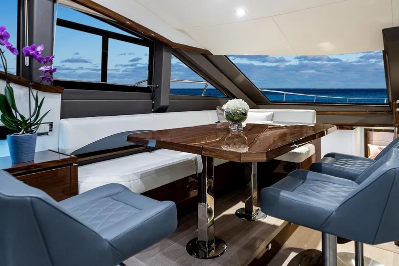  Yacht Photos Pics Luxurious interior of 2026 Neptunus 650E yacht with elegant dining area and ocean view.