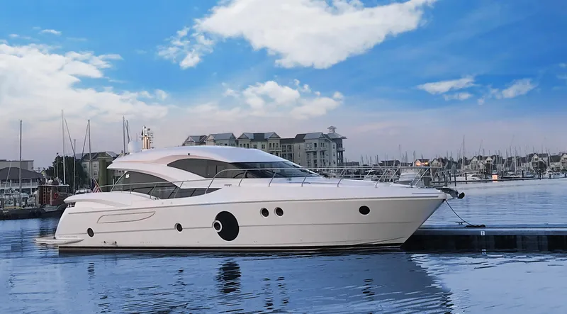  Yacht Photos Pics Luxury Neptunus 650E yacht docked at marina, 2026 model, under clear blue sky.