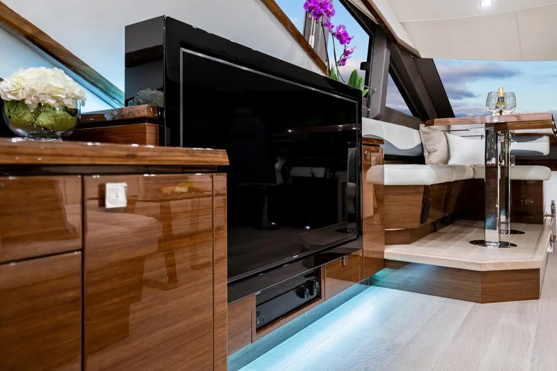  Yacht Photos Pics Luxurious interior of 2026 Neptunus 650E yacht with modern entertainment system and elegant seating.