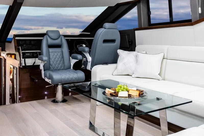  Yacht Photos Pics Luxurious interior of 2026 Neptunus 650E yacht with modern seating and glass table.