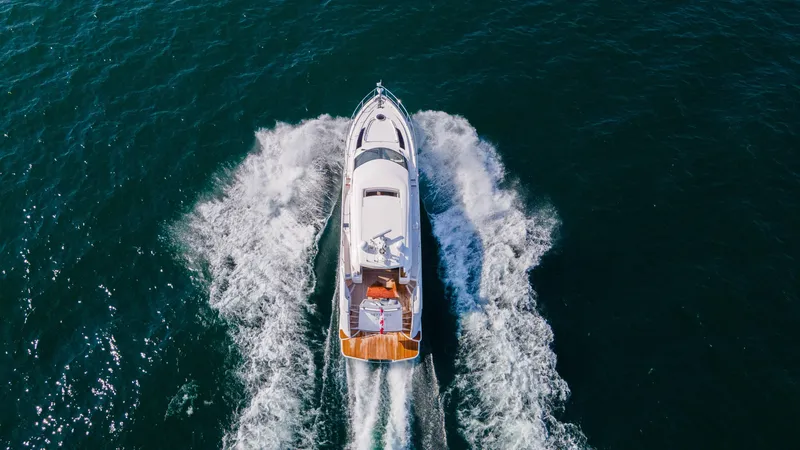  Yacht Photos Pics Aerial view of 2026 Neptunus 650E yacht cruising on open water.