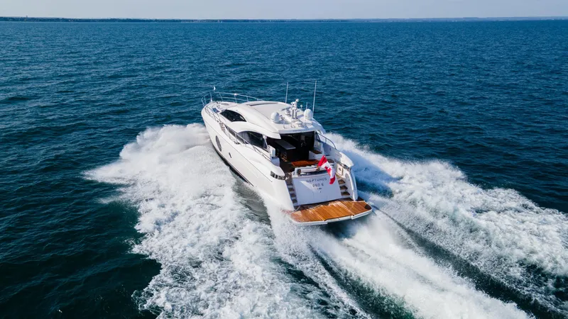  Yacht Photos Pics Luxurious 2026 Neptunus 650E yacht cruising on open sea, creating dynamic water trails.