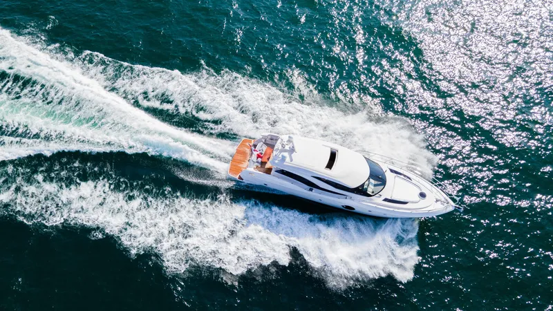  Yacht Photos Pics Aerial view of 2026 Neptunus 650E yacht cruising on open water.