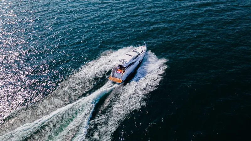  Yacht Photos Pics Aerial view of 2026 Neptunus 650E yacht cruising on open water.