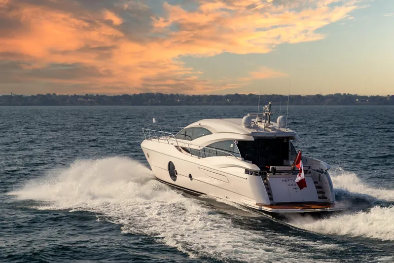  Yacht Photos Pics Luxurious 2026 Neptunus 650E yacht cruising at sunset on open water.