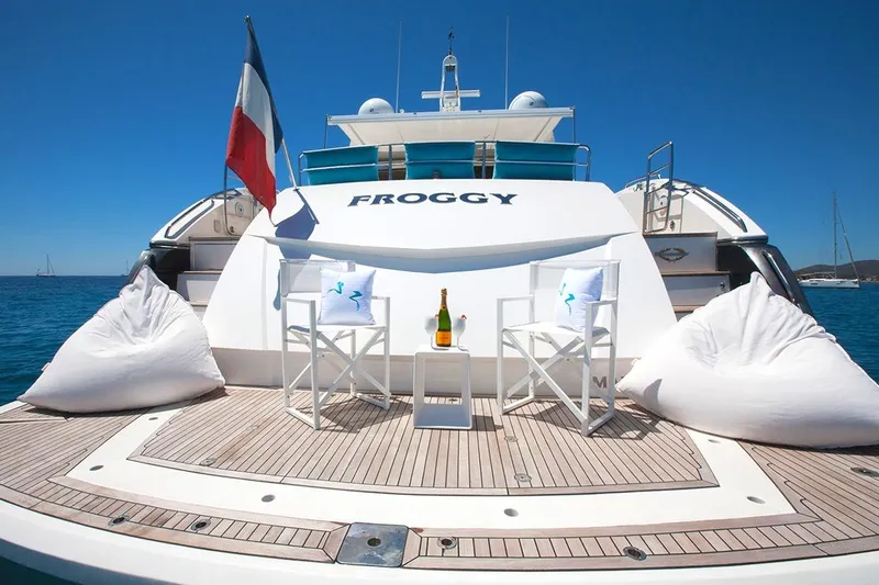 Froggy Yacht Photos Pics Luxury Sunseeker Predator 82 yacht deck with seating, champagne, and ocean view, 2006 model.