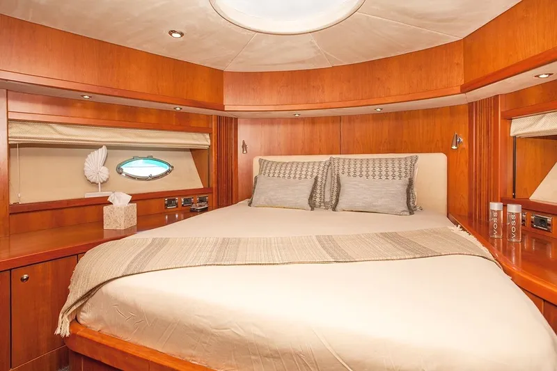 Froggy Yacht Photos Pics Luxurious bedroom interior of 2006 Sunseeker Predator 82 yacht with elegant wood finish.