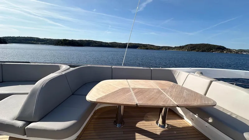 F65012 Yacht Photos Pics Luxurious 2024 Princess F65 yacht deck with elegant seating and scenic ocean view.