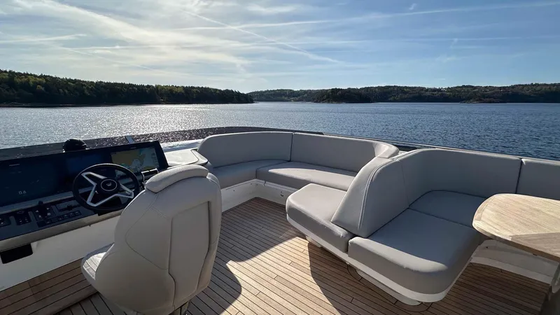 F65012 Yacht Photos Pics 2024 Princess F65 yacht with luxurious seating and scenic lake view.