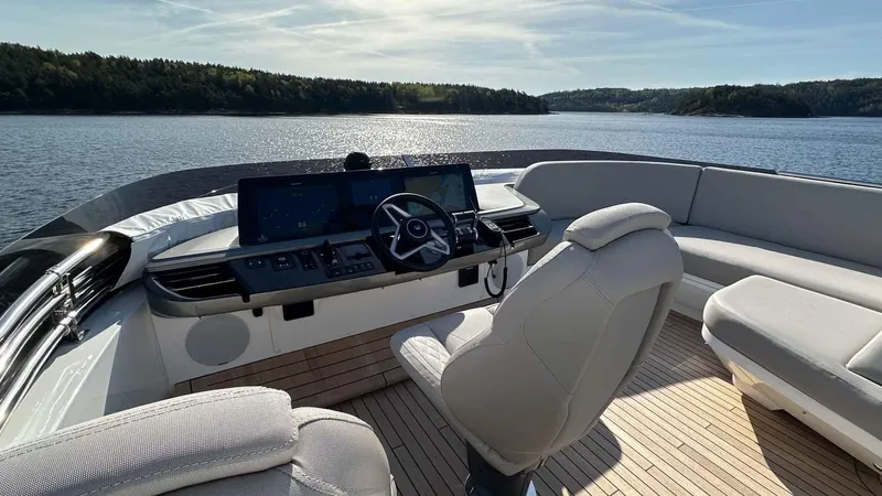 F65012 Yacht Photos Pics 2024 Princess F65 yacht helm with luxurious seating and scenic water view.