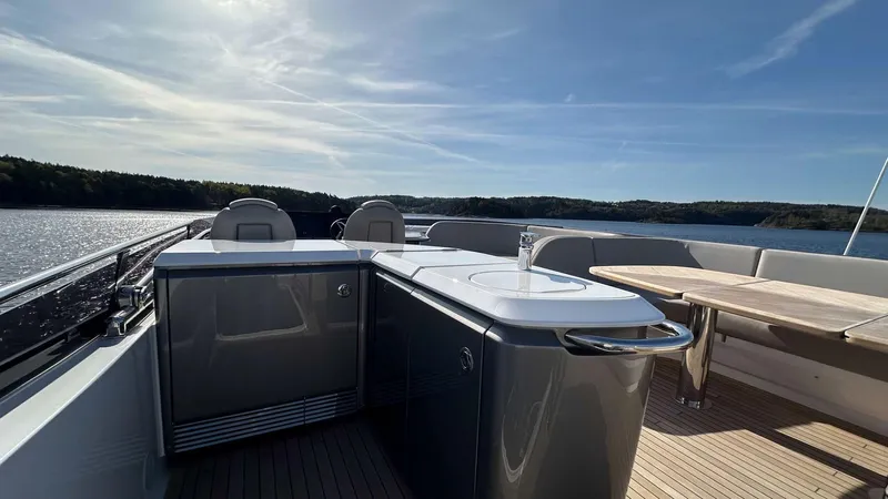 F65012 Yacht Photos Pics Luxurious 2024 Princess F65 yacht deck with outdoor kitchen and seating area.