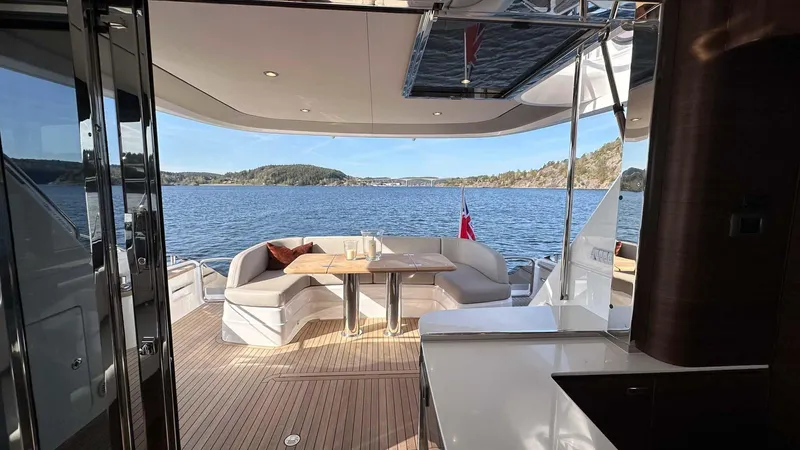 F65012 Yacht Photos Pics Luxurious 2024 Princess F65 yacht interior with scenic ocean view and elegant seating area.