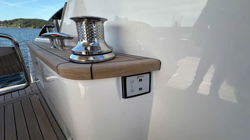 F65012 Yacht Photos Pics 2024 Princess F65 yacht deck with winch and control panel, featuring sleek design and wood accents.
