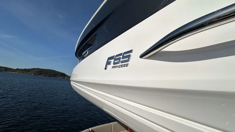F65012 Yacht Photos Pics 2024 Princess F65 yacht on water, showcasing sleek design and branding.