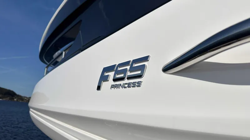 F65012 Yacht Photos Pics 2024 Princess F65 yacht, sleek design, ocean backdrop, close-up of model emblem.