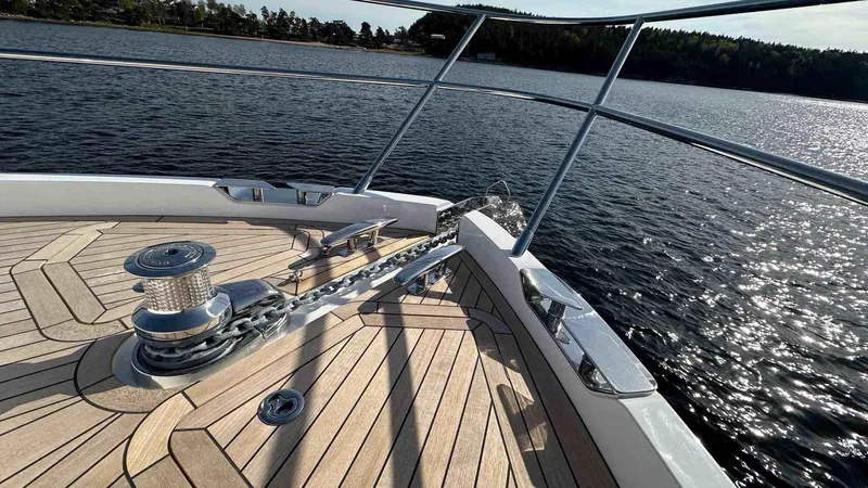 F65012 Yacht Photos Pics Bow of 2024 Princess F65 yacht with teak deck on a sunny day.