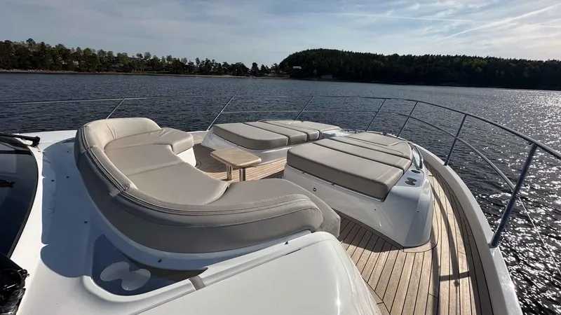 F65012 Yacht Photos Pics Luxurious 2024 Princess F65 yacht deck with elegant seating, overlooking serene waters.