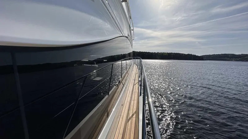 F65012 Yacht Photos Pics 2024 Princess F65 yacht cruising on a sunny day, reflecting on calm waters.