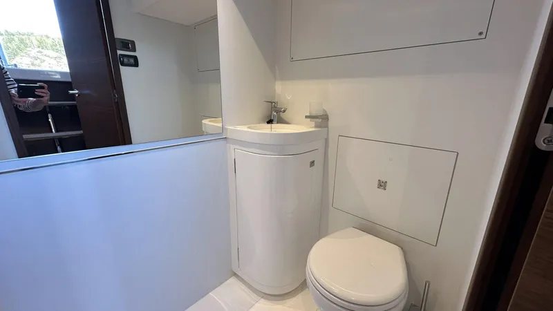 F65012 Yacht Photos Pics Modern bathroom in 2024 Princess F65 yacht with sleek sink and toilet.