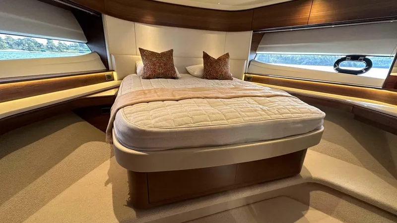 F65012 Yacht Photos Pics Luxurious bedroom interior of 2024 Princess F65 yacht with elegant bedding and ambient lighting.