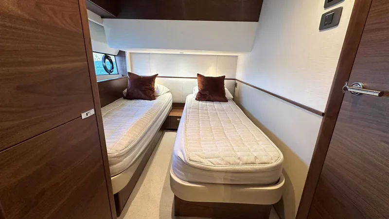 F65012 Yacht Photos Pics 2024 Princess F65 yacht cabin with twin beds, wooden accents, and modern design.