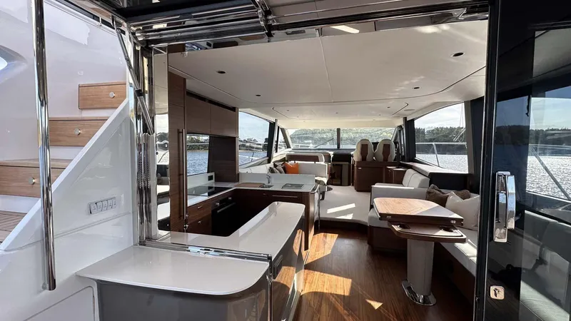 F65012 Yacht Photos Pics Luxurious interior of 2024 Princess F65 yacht with modern furnishings and scenic water views.
