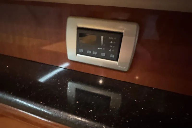  Yacht Photos Pics Control panel on 2008 Meridian 580 Pilothouse yacht, mounted on a glossy wooden surface.