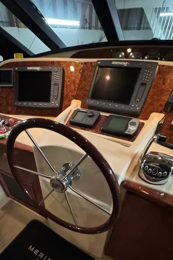  Yacht Photos Pics Pilothouse of 2008 Meridian 580 with navigation screens and steering wheel.