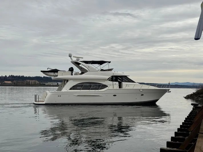  Yacht Photos Pics 2008 Meridian 580 Pilothouse yacht on calm water under cloudy sky.