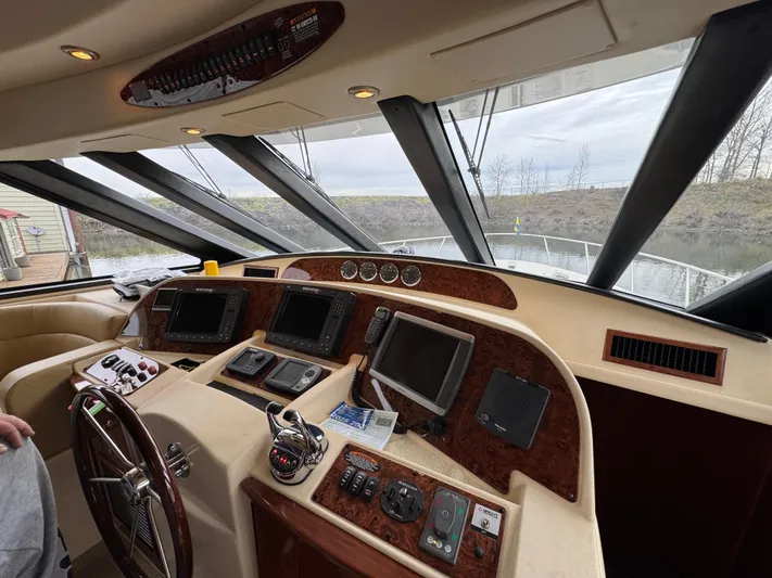  Yacht Photos Pics Pilothouse interior of 2008 Meridian 580, featuring navigation equipment and panoramic windows.