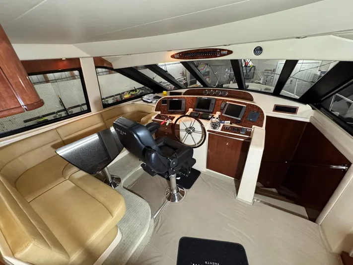  Yacht Photos Pics Pilothouse interior of 2008 Meridian 580, featuring helm station and seating area.