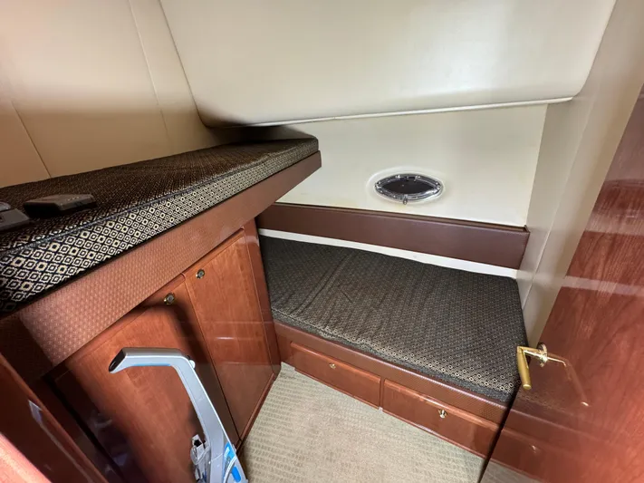  Yacht Photos Pics 2008 Meridian 580 Pilothouse cabin with single bed, wooden cabinetry, and small porthole window.